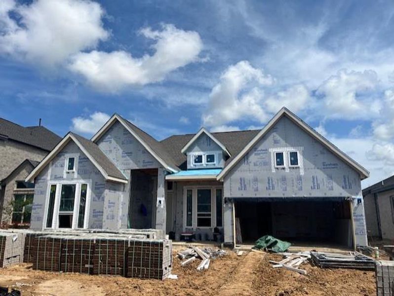Front exterior of a new home in Elyson, Katy, TX, highlighting curb appeal (Image 15). Front exterior of a new home in Elyson, Katy, TX, highlighting curb appeal (Image 15).