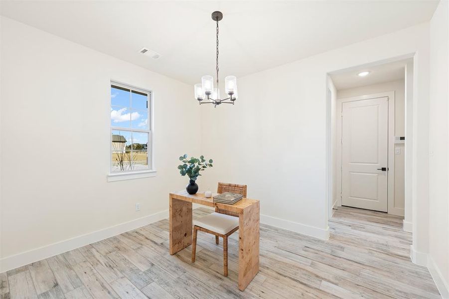 Dining space with a chandelier and light wood finished floors