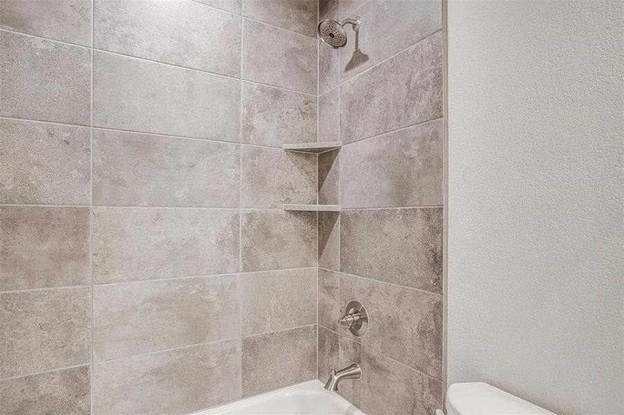 Room details featuring toilet and shower / bath combination