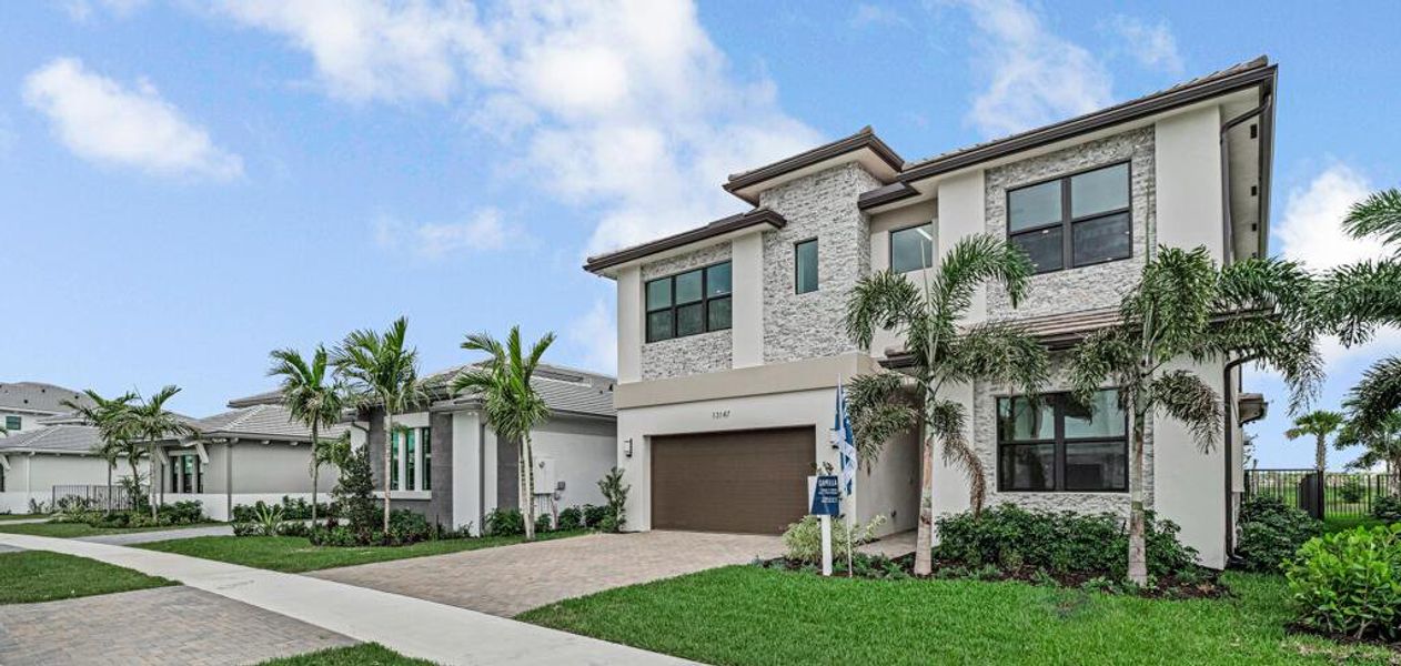Front exterior of a new home in Apex at Avenir, Palm Beach Gardens, FL, highlighting curb appeal (Image 27).