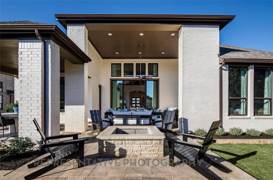 View of patio featuring an outdoor living space with a fire pit