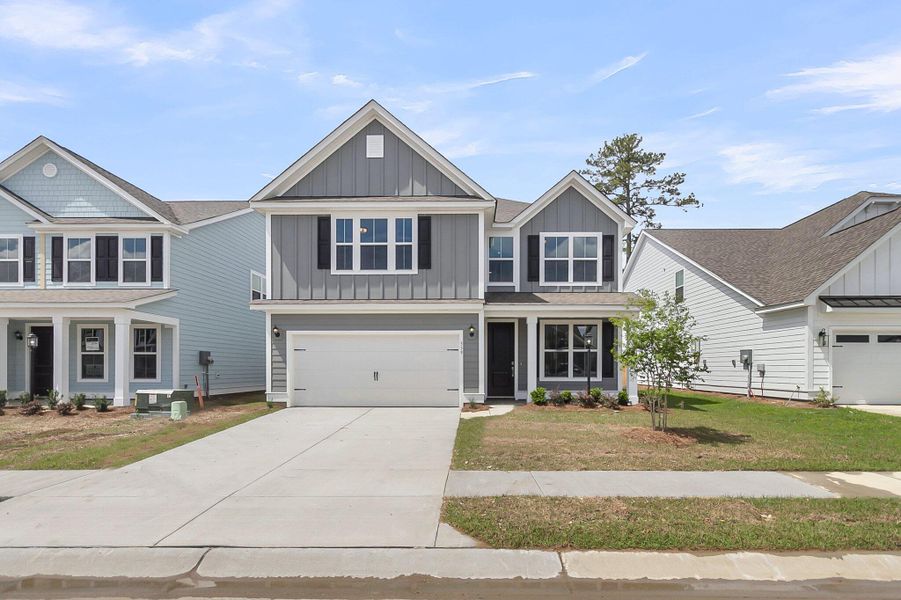 Front exterior of a new home in High Point at Foxbank, Moncks Corner, SC, highlighting curb appeal (Image 21). Front exterior of a new home in High Point at Foxbank, Moncks Corner, SC, highlighting curb appeal (Image 21).