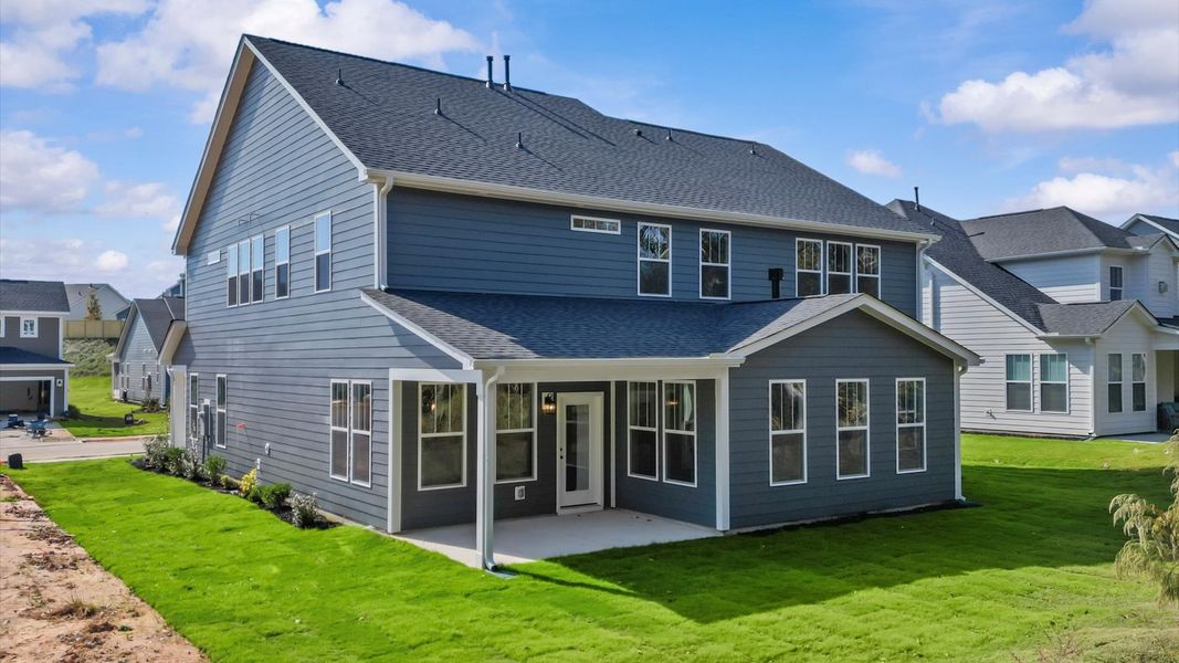 Vibrant rear outdoor space featuring a covered porch and exceptional craftsmanship