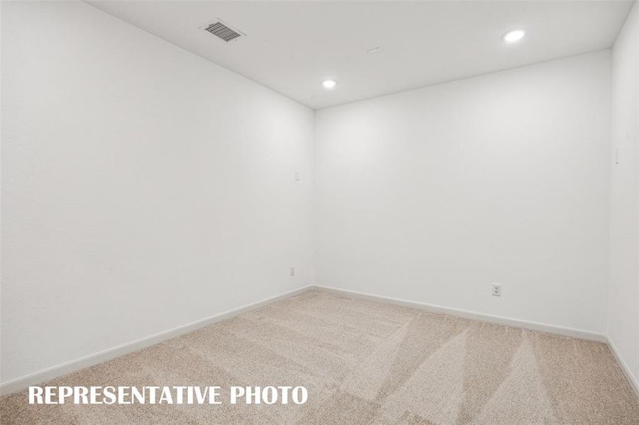 This spacious media room with adjacent game room create the ultimate family entertainment zone!  REPRESENTATIVE PHOTO