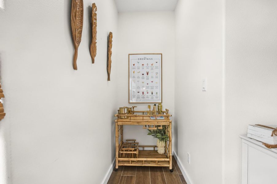 Hallway featuring dark wood finished floors and baseboards Hallway featuring dark wood finished floors and baseboards