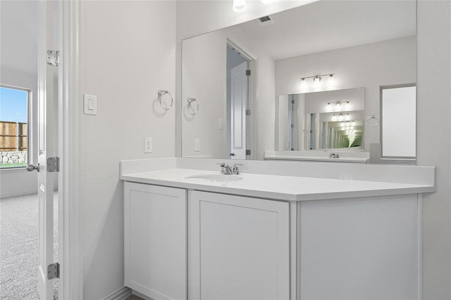 Half bathroom featuring vanity and baseboards Half bathroom featuring vanity and baseboards