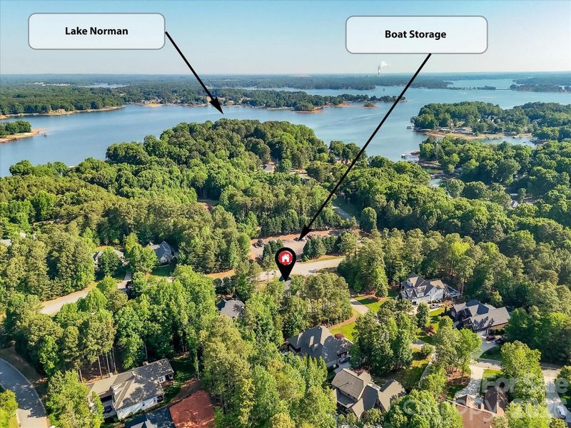 Aerial view showcasing the home’s prime location in a wooded community with nearby lake access and convenient neighborhood boat storage. Aerial view showcasing the home’s prime location in a wooded community with nearby lake access and convenient neighborhood boat storage.