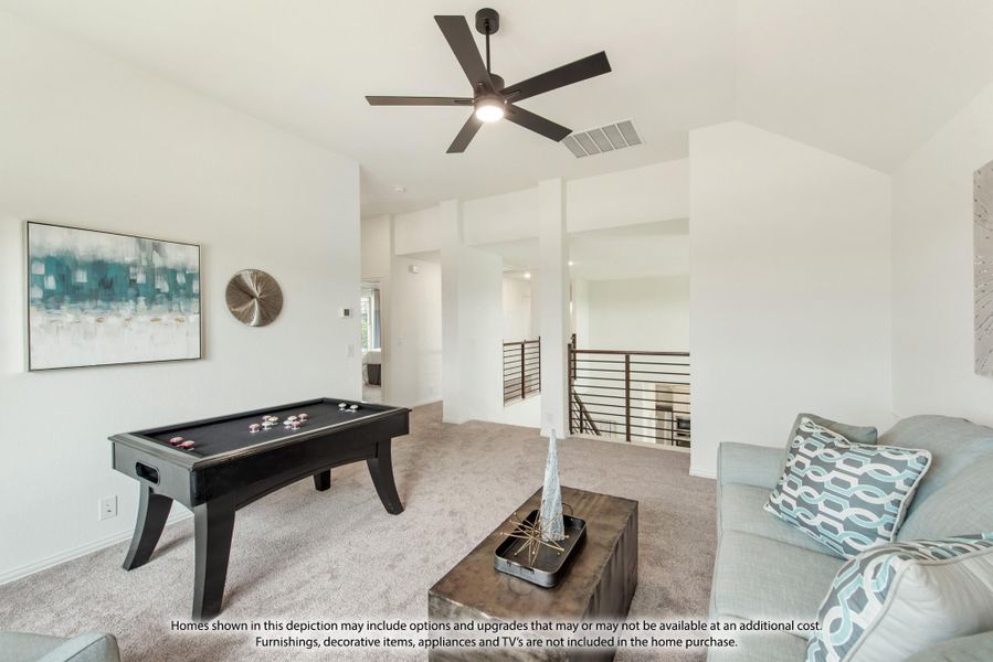 Upstairs game room with air hockey table, ceiling fan, and open railing overlooking lower level