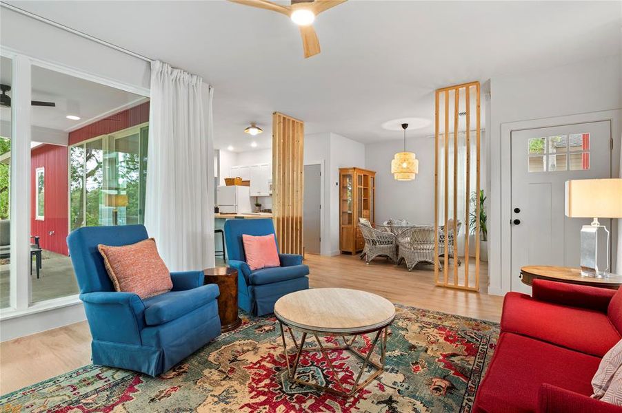 Living room featuring wood-type flooring and ceiling fan