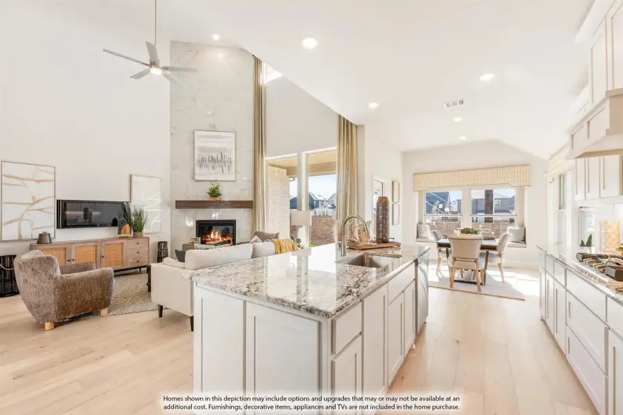 Open-concept kitchen with granite island flowing into living room with vaulted ceiling and stone fireplace