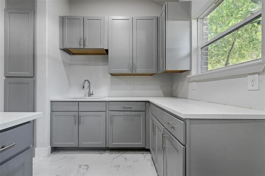 Kitchen with sink and gray cabinetry