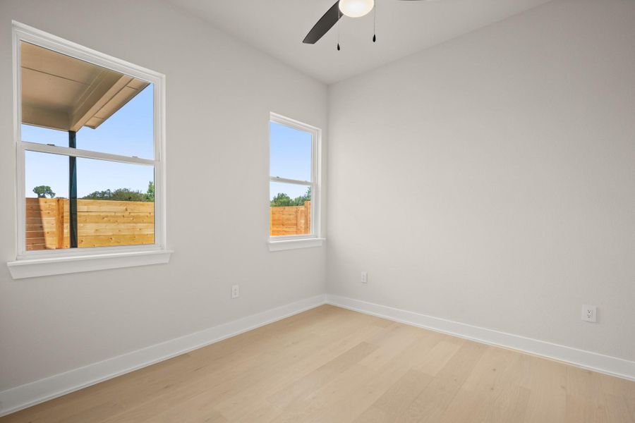 Unfurnished room with wood finished floors and ceiling fan