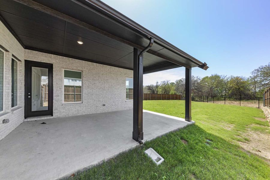 Exterior details and patio area of a home in The Reserve at Spiritas Ranch, Little Elm (Image 3).