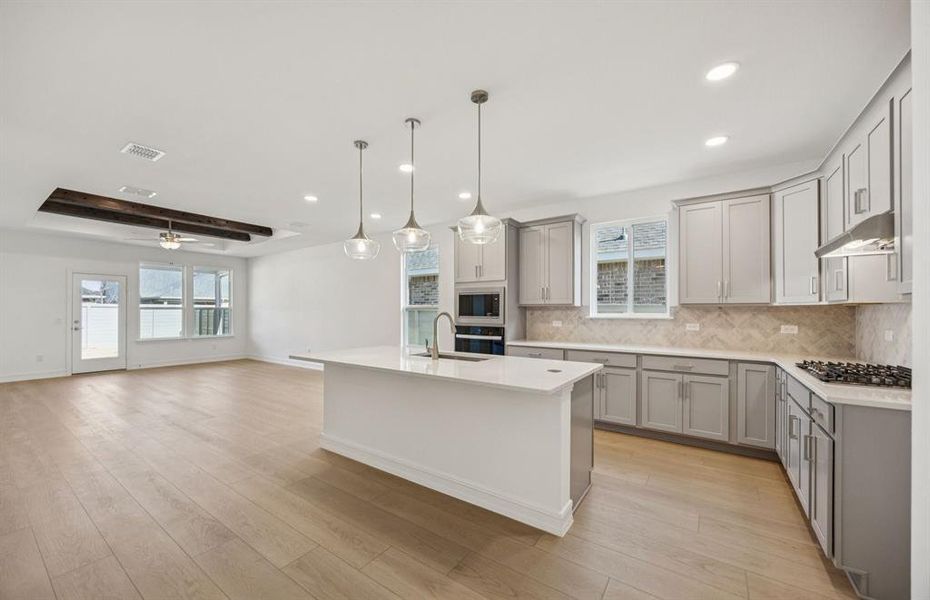 Open concept living areas with eat-in island and large gathering room Open concept living areas with eat-in island and large gathering room