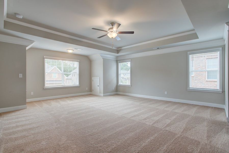 Luxurious master bedroom includes a sitting area overlooking the frontyard