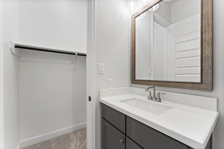 Upgraded, framed mirror, beautiful vanity, and direct access to the closet make getting ready effortless. Upgraded, framed mirror, beautiful vanity, and direct access to the closet make getting ready effortless.