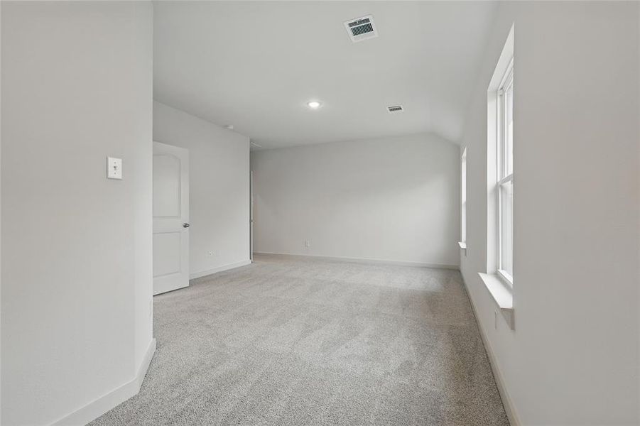 Spare room featuring light colored carpet, lofted ceiling, and recessed lighting Spare room featuring light colored carpet, lofted ceiling, and recessed lighting