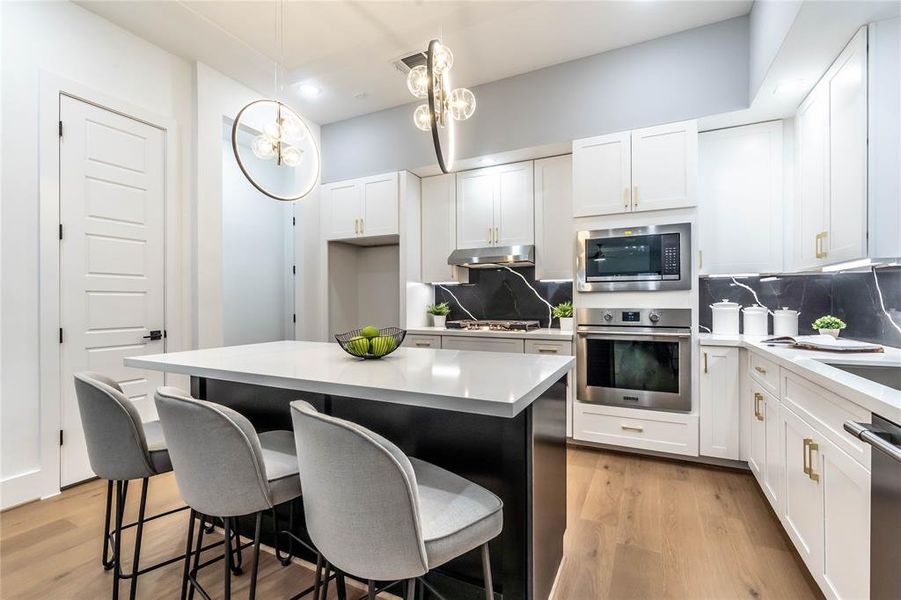 A spacious kitchen and pantry, with the garage entry located in the back corner.