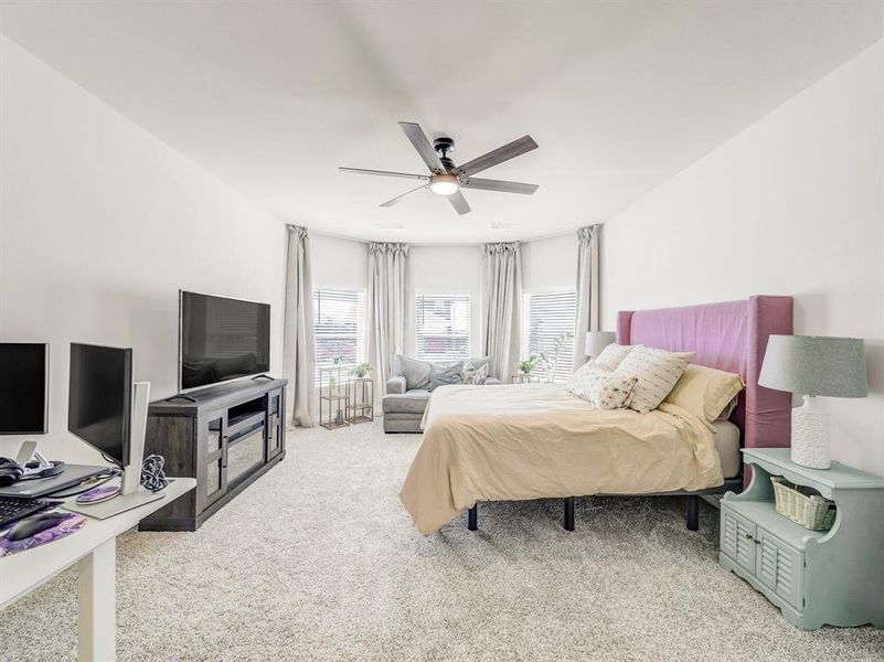 Bedroom featuring light colored carpet and ceiling fan