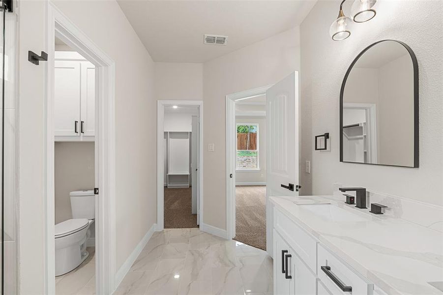 Bathroom with vanity, tile patterned flooring, and toilet