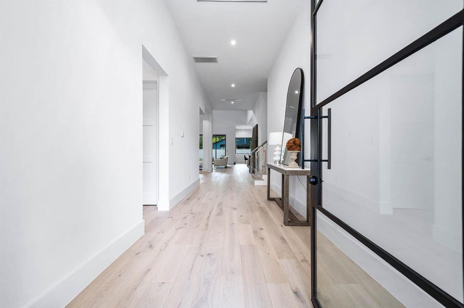 Inviting entryway showcasing a striking 9-foot glass door that fills the space with natural light and sets an elegant first impression.