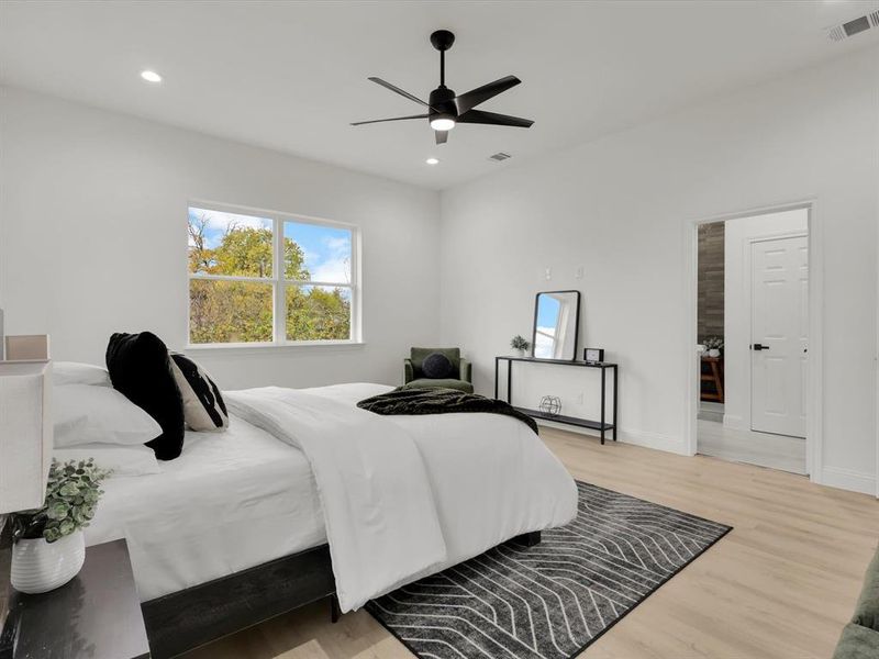 Bedroom featuring light hardwood / wood-style floors and ceiling fan