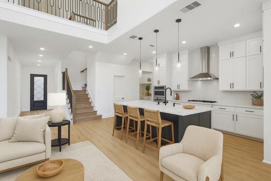 Living area with light wood-style flooring, stairs, and recessed lighting virtually stage
