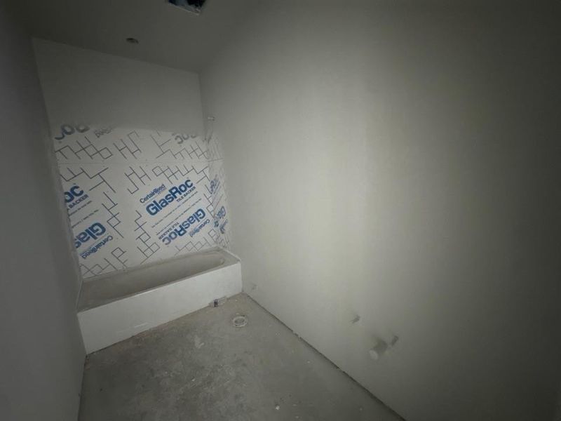 Full bath with concrete floors