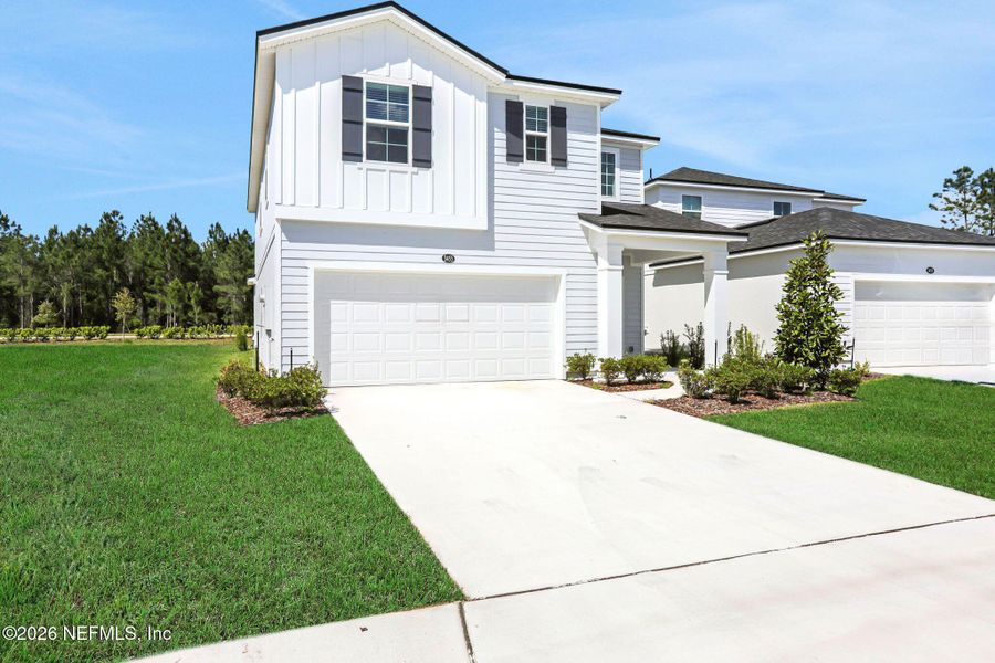 Front exterior of a new home in Amberly, Green Cove Springs, FL, highlighting curb appeal (Image 24).