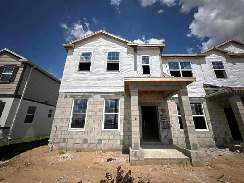 Front exterior of a new home in Tribute at Ovation, Winter Garden, FL, highlighting curb appeal (Image 22).