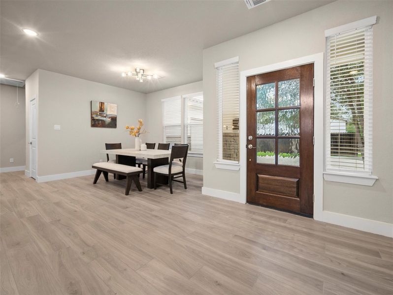 Dining space with light wood-style floors and baseboards Dining space with light wood-style floors and baseboards