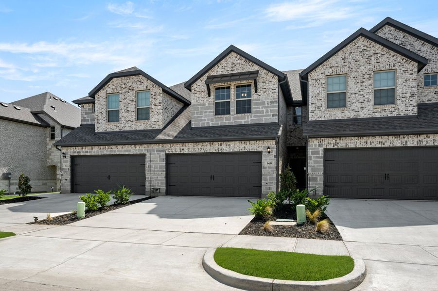 Front exterior of a new home in Main Street Village, Mansfield, TX, highlighting curb appeal (Image 2). Front exterior of a new home in Main Street Village, Mansfield, TX, highlighting curb appeal (Image 2).