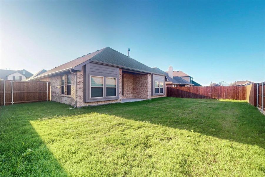 Rear view of property featuring brick siding and a chimney