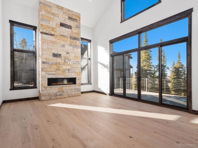 Stone wrapped gas fireplace out to walk out deck Stone wrapped gas fireplace out to walk out deck