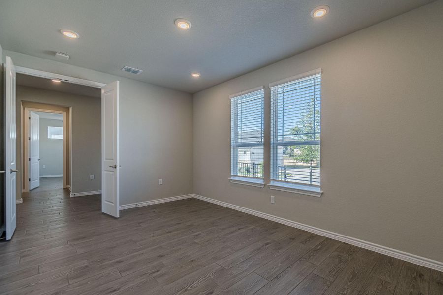 Unfurnished room with dark wood-style floors and recessed lighting Unfurnished room with dark wood-style floors and recessed lighting