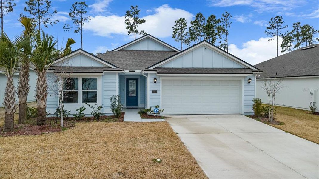 Front exterior of a new home in Sawmill Branch, Palm Coast, FL, highlighting curb appeal (Image 1). Front exterior of a new home in Sawmill Branch, Palm Coast, FL, highlighting curb appeal (Image 1).