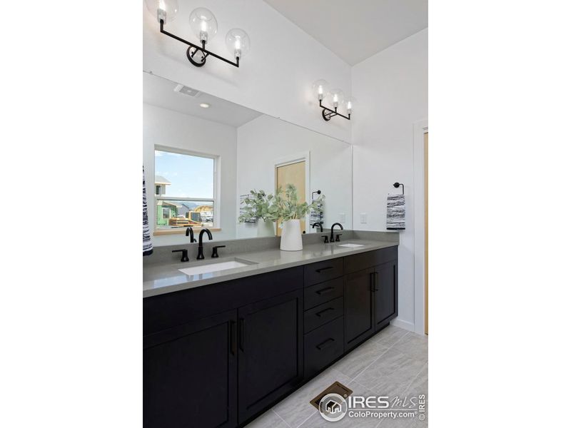 Primary bathroom double vanity with undermount sinks