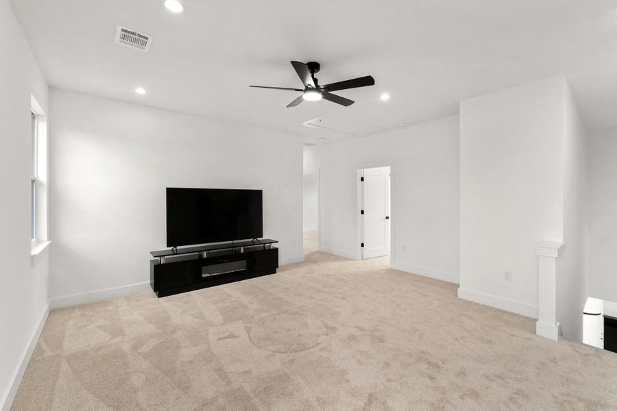 Unfurnished living room with light carpet, ceiling fan, and recessed lighting