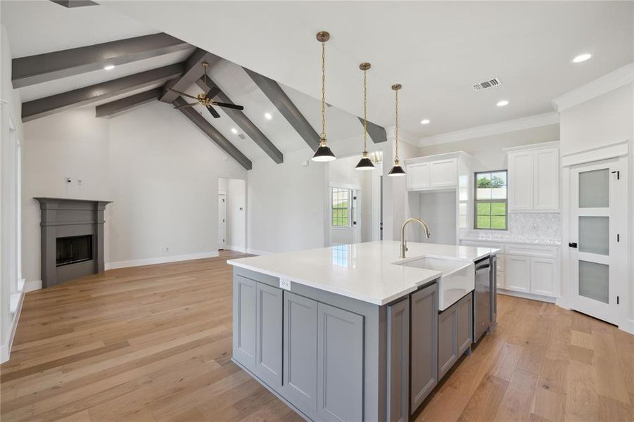 Kitchen with white cabinetry, light hardwood / wood-style flooring, tasteful backsplash, and gray cabinetry