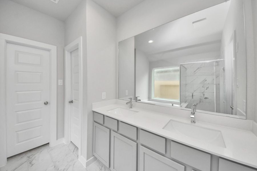 Escape to a spa-like oasis in this primary bathroom. Enjoy a walk-in shower with tile surround, a separate garden tub with custom detailing, and an elegant vanity featuring light countertops, modern hardware, and beautiful recessed lights. Experience luxury and relaxation in every detail. Sample photo of completed home with similar floor plan. Actual colors and selections may vary. Escape to a spa-like oasis in this primary bathroom. Enjoy a walk-in shower with tile surround, a separate garden tub with custom detailing, and an elegant vanity featuring light countertops, modern hardware, and beautiful recessed lights. Experience luxury and relaxation in every detail. Sample photo of completed home with similar floor plan. Actual colors and selections may vary.