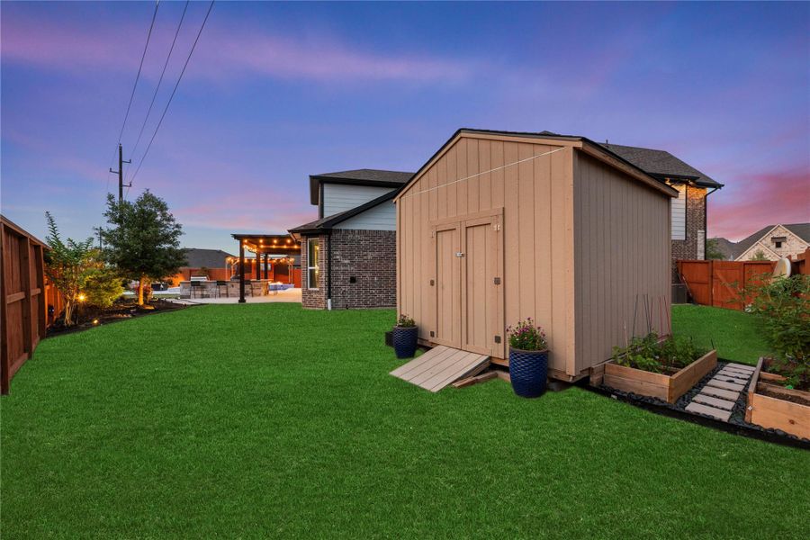 A storage shed is well utilized in the large side yard. It also has a rock climbing wall and provides some shade for the planters for your herb and vegetable garden.