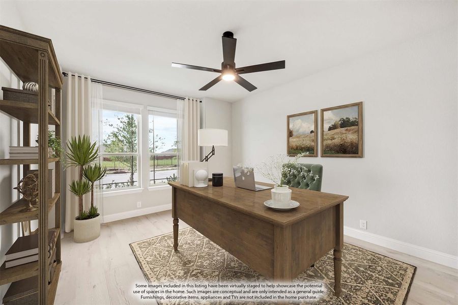 Home office with wood desk, ceiling fan, light wood floors, and large window