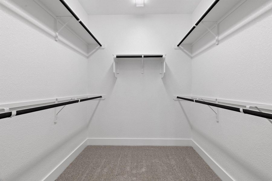 Walk-in closet in Primary Bedroom Walk-in closet in Primary Bedroom