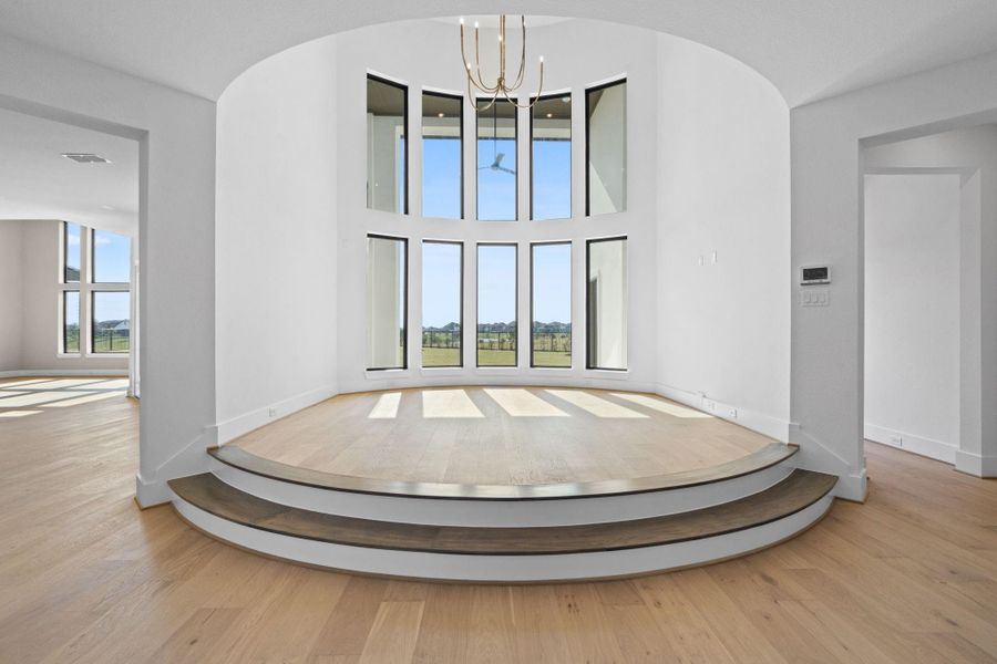View of the exquisite, elevated Living Room with stacked windows towards the Butler's Pantry, Kitchen and Family Room that's coming along beautifully. View of the exquisite, elevated Living Room with stacked windows towards the Butler's Pantry, Kitchen and Family Room that's coming along beautifully.