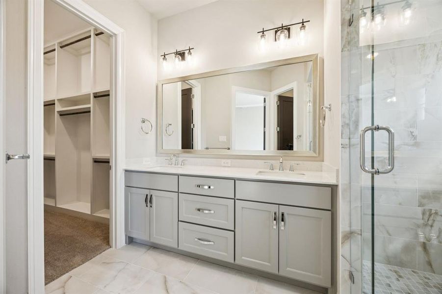 Double vanity and view of large walk-in closet. Double vanity and view of large walk-in closet.