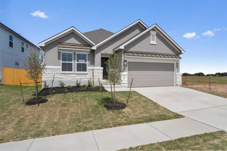 Front exterior of a new home in Butler Farms, Liberty Hill, TX, highlighting curb appeal (Image 1). Front exterior of a new home in Butler Farms, Liberty Hill, TX, highlighting curb appeal (Image 1).