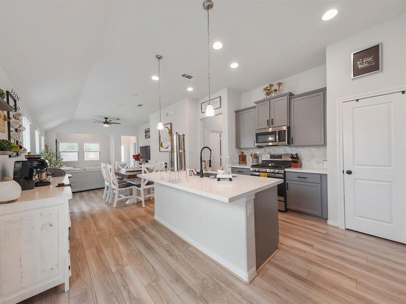 This is a lovely view with stainless steel appliances with white quartz countertops to add to the bling of this kitchen.