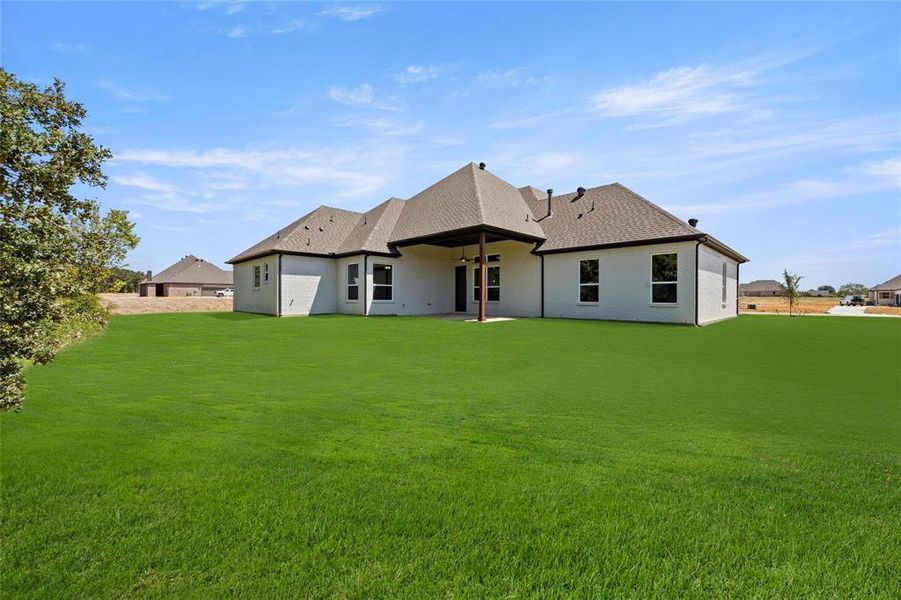 Back of property with a patio and a yard