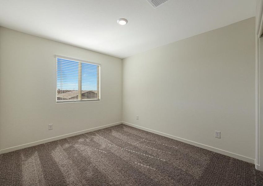 Windows let in plenty of light to this secondary bedroom.