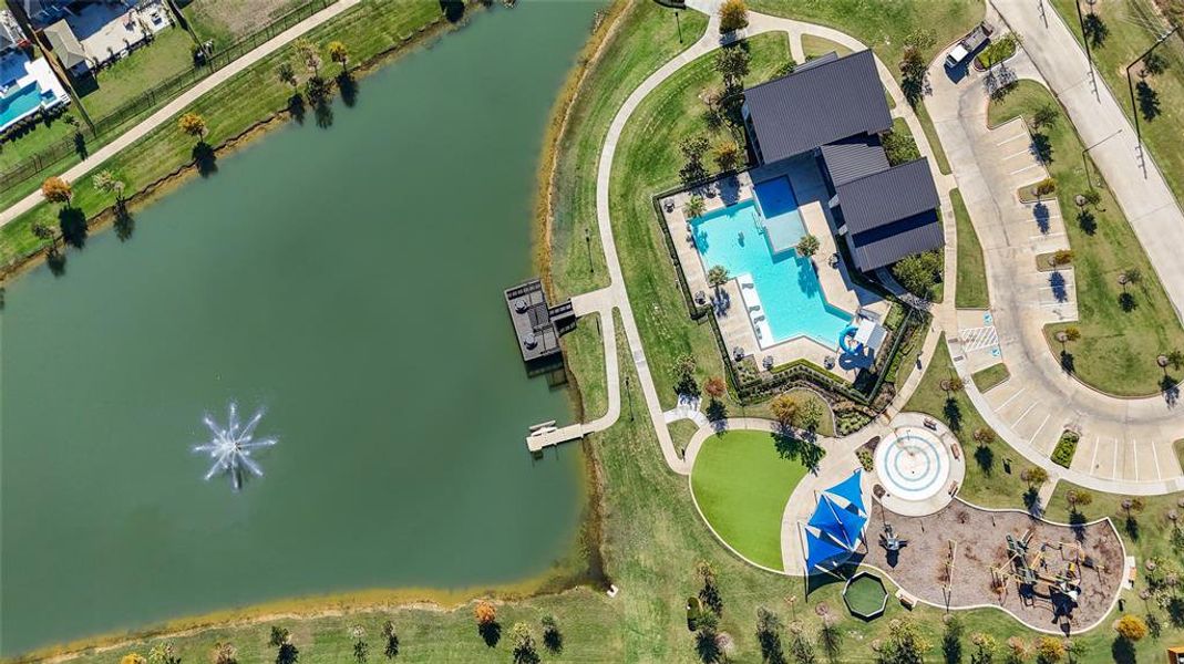 A view of the resort style pool, playground, splashpad and community center